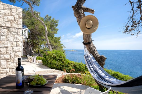 Sea view from the terrace with a table and a swing